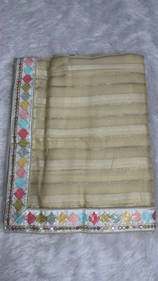 BEIGE SOFT NET SAREE WITH WHITE DESIGNER BLOUSE.